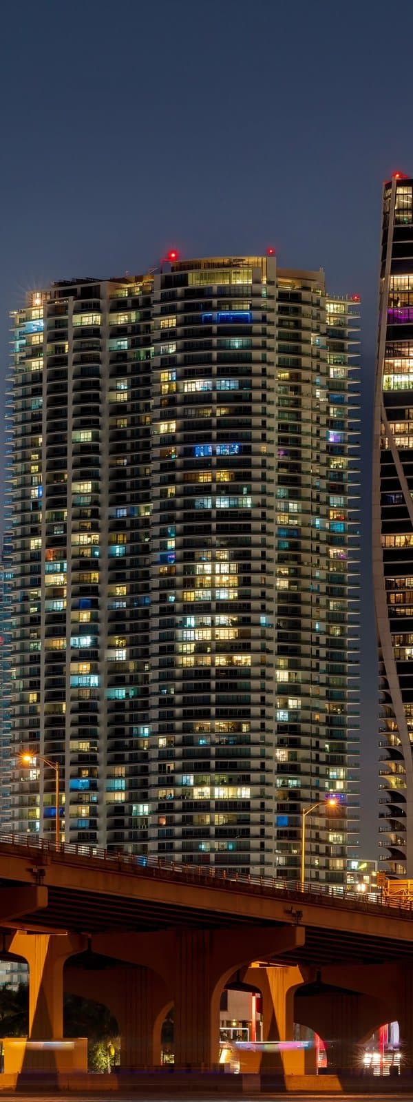 Downtown Miami towers lit at night above the river