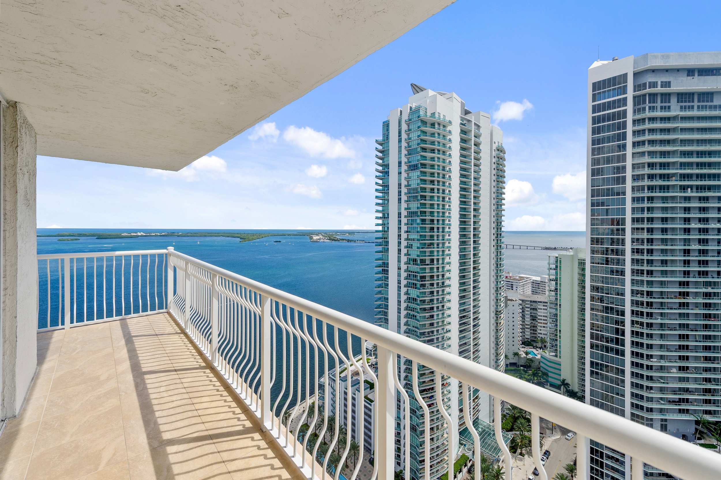 Step out onto the private balcony overlooking the city skyline.