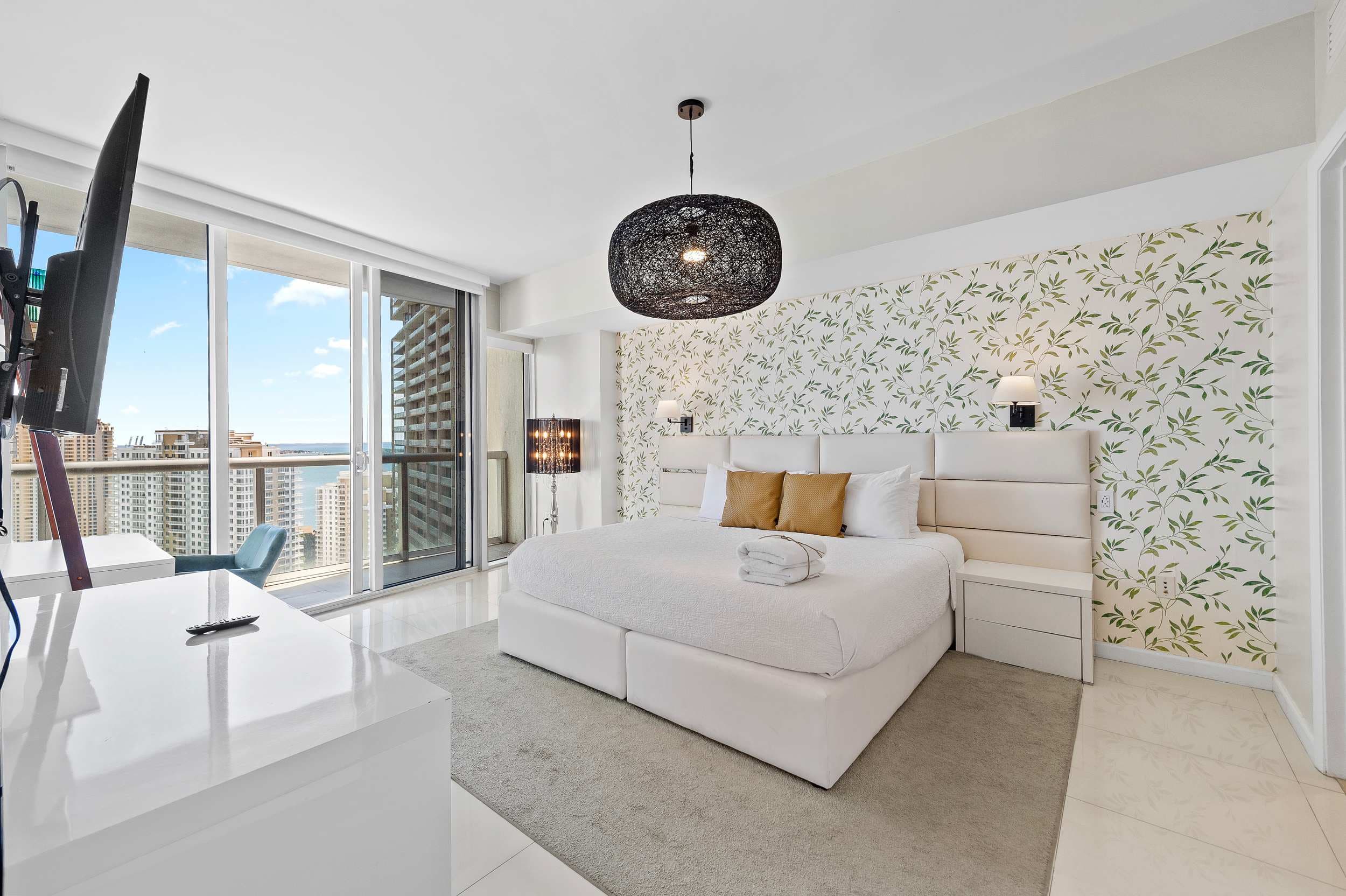 Bright master bedroom with balcony access.