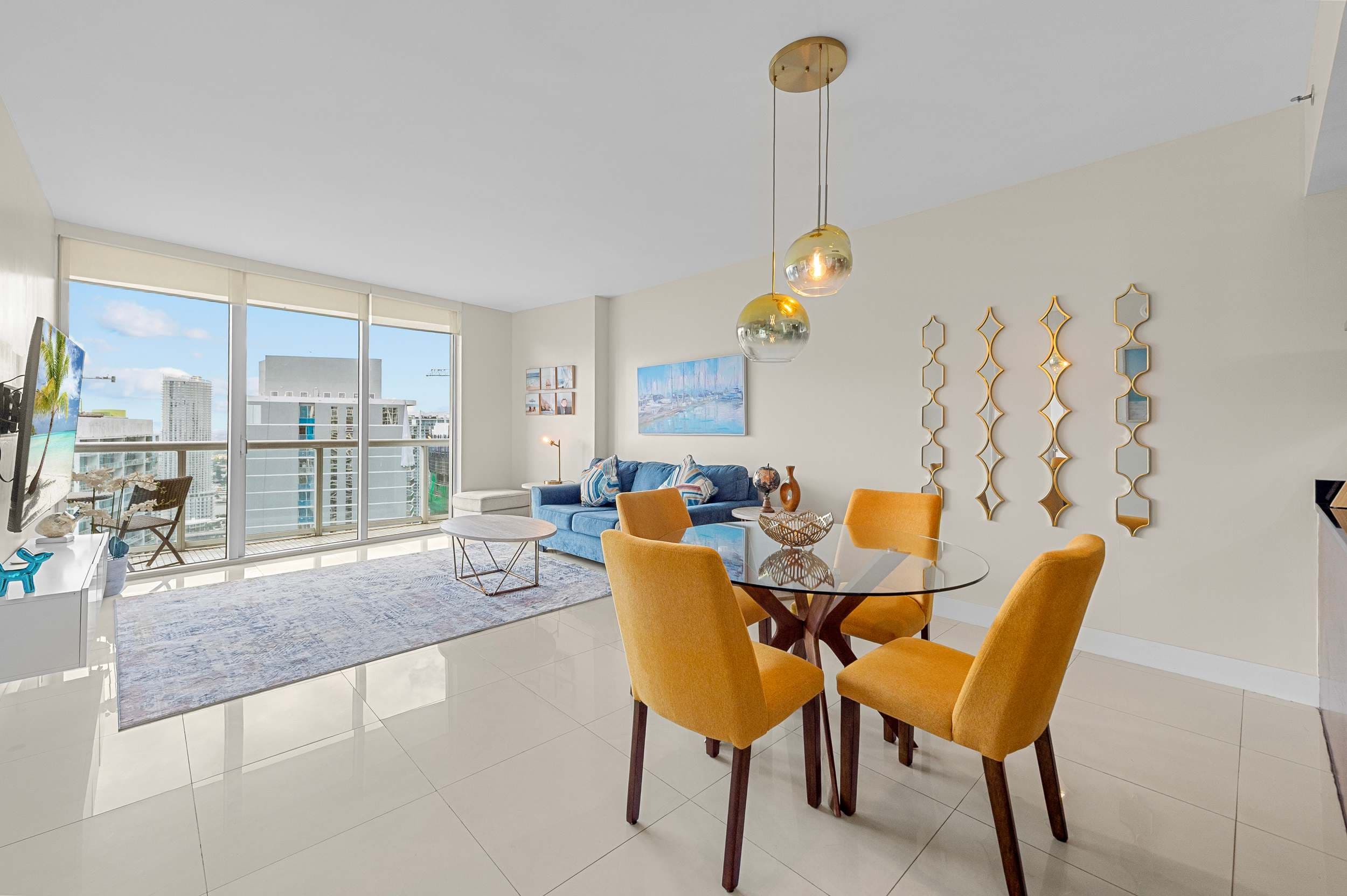Bright, open-concept living and dining space with floor-to-ceiling windows.