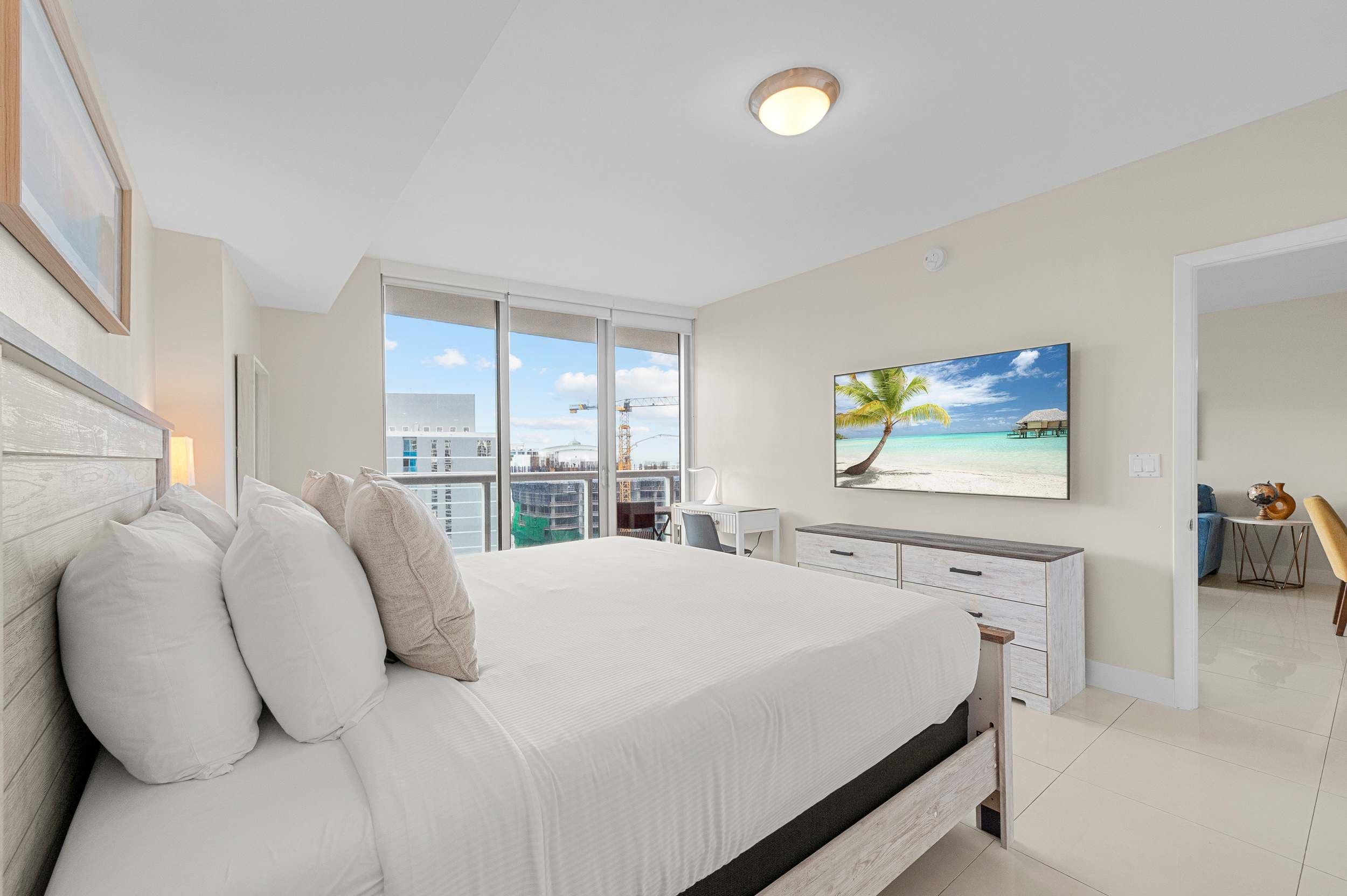 Plush king bed surrounded by crisp, modern interior styling.