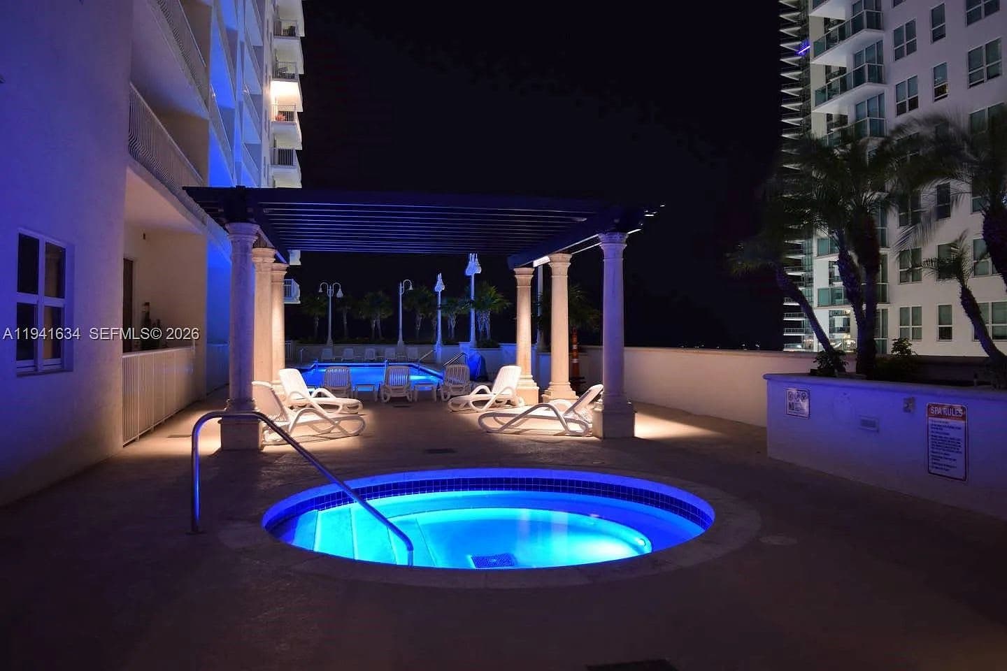 The outdoor pool terrace and sun loungers at The Club at Brickell Bay