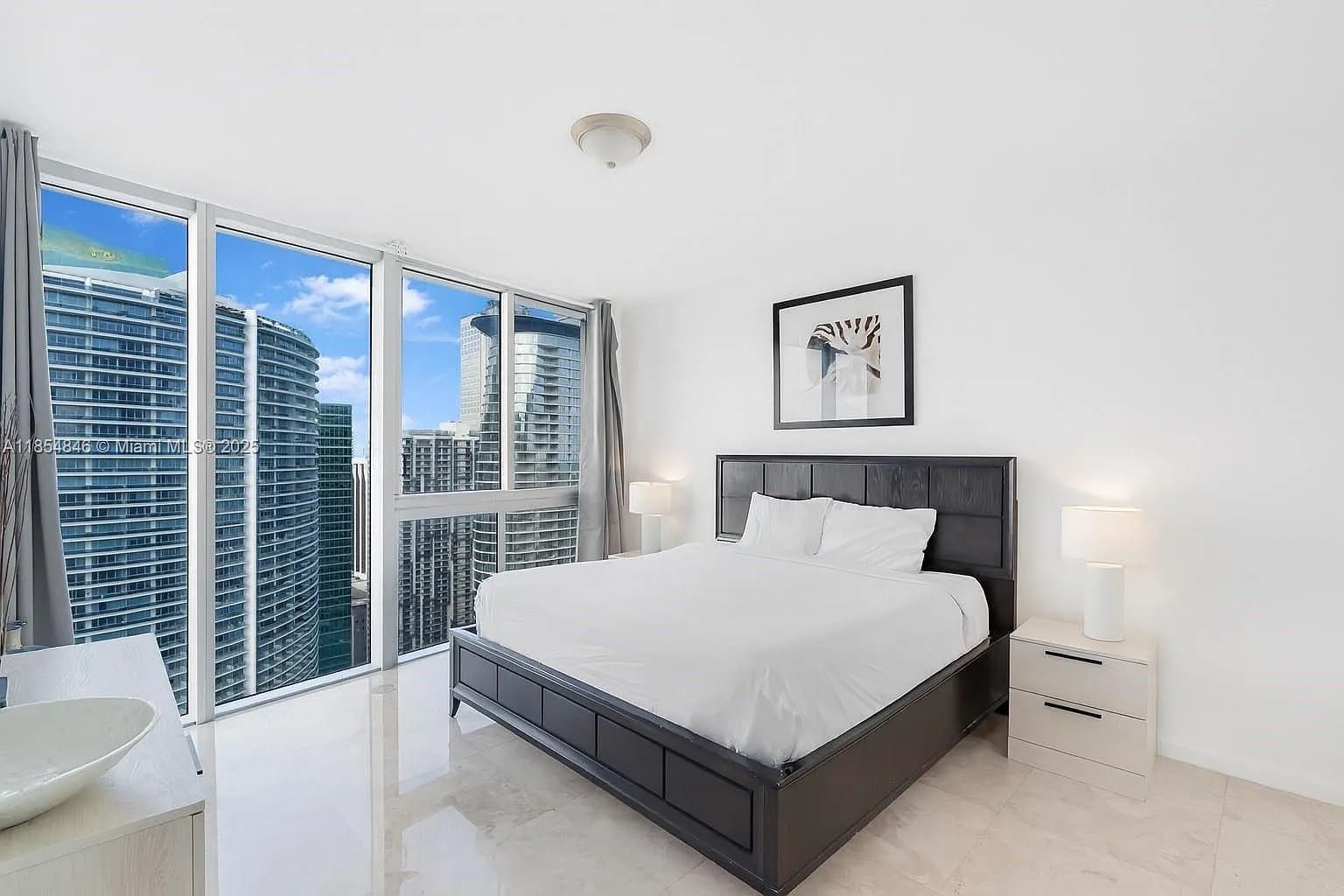 Minimalist modern bedroom flooded with natural light.