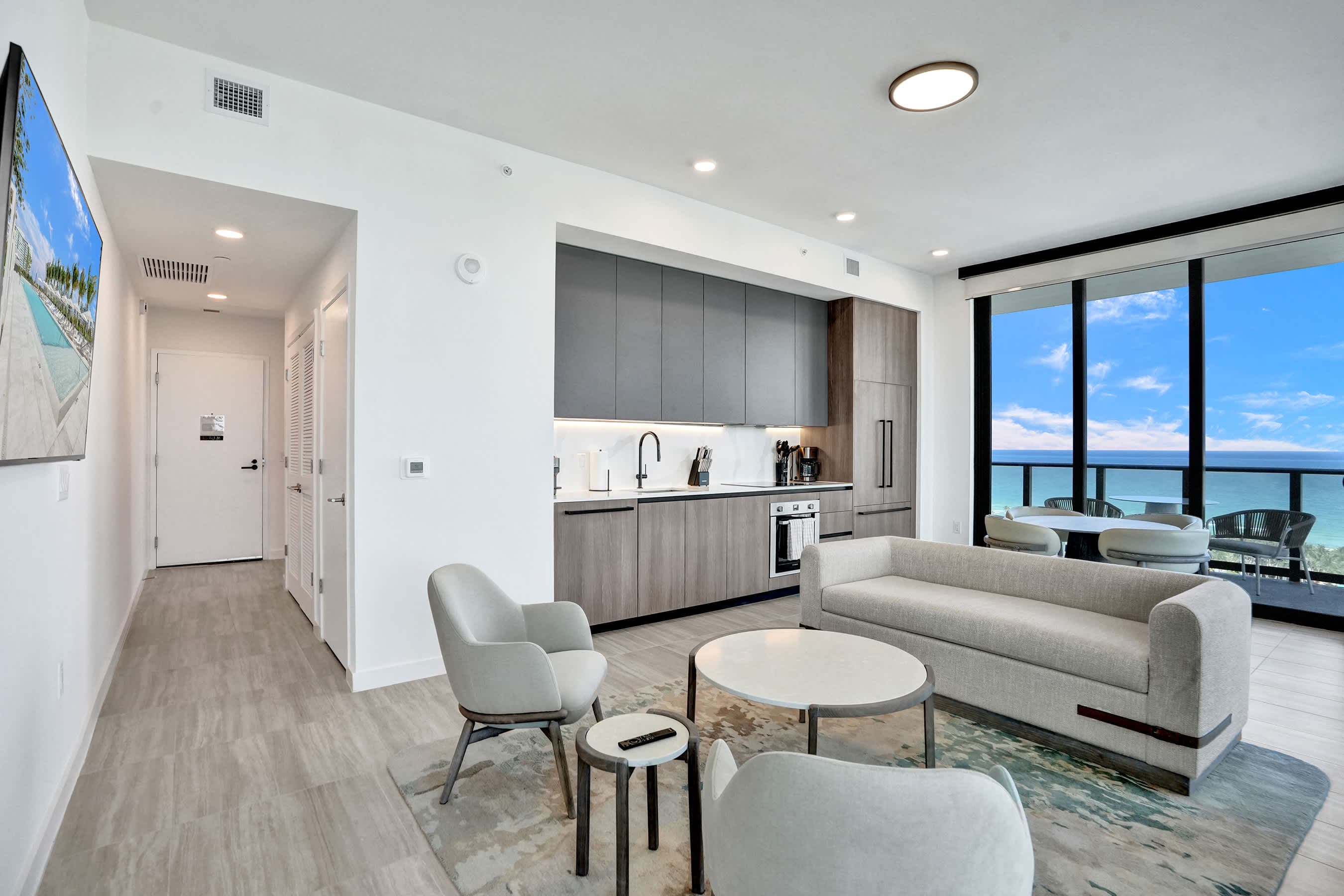Seamless flow with ocean view between modern dining and lounging areas.