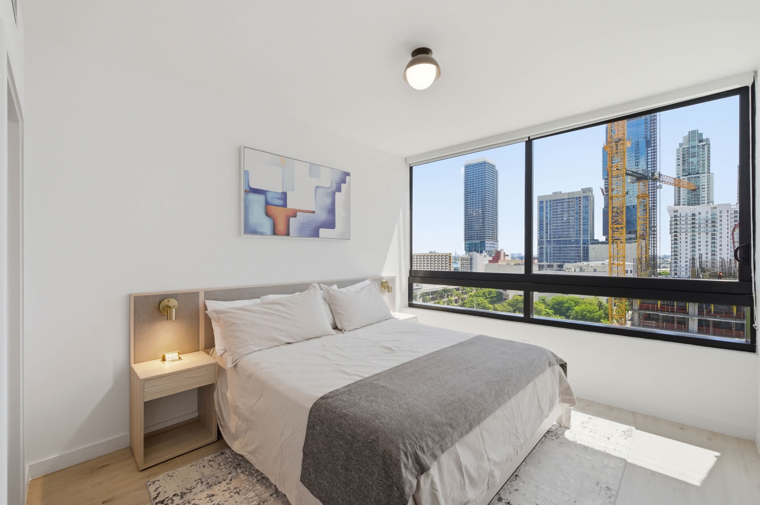 Cozy Bedroom with City Skyline Views