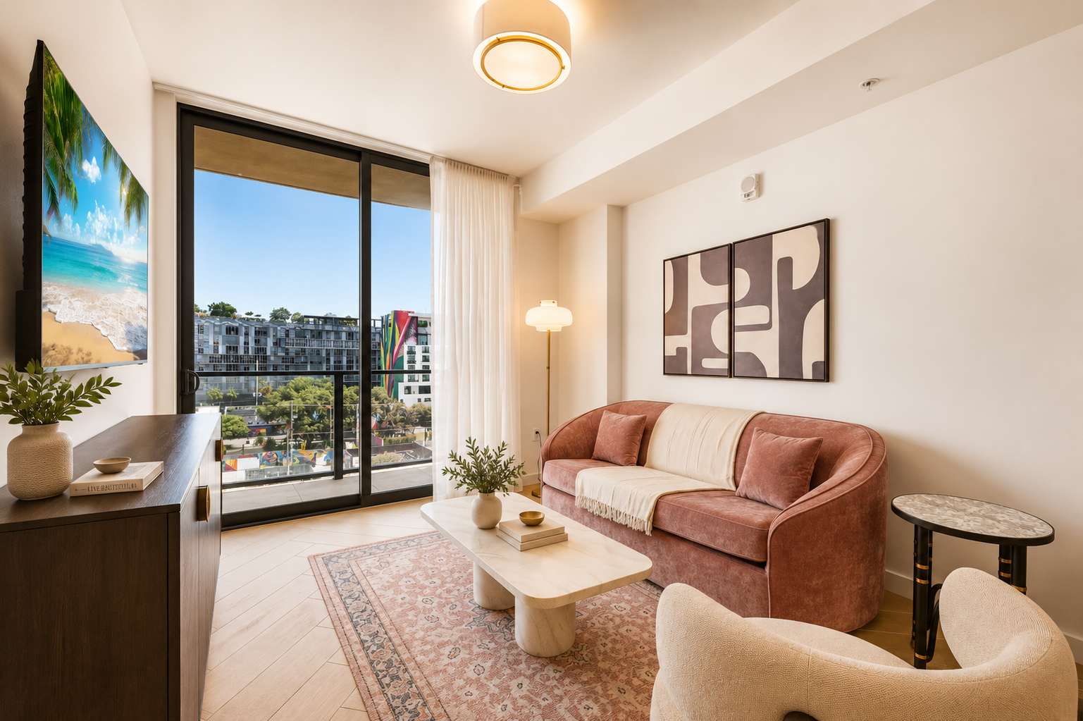 Chic, sunlit living space with a private city-view balcony.