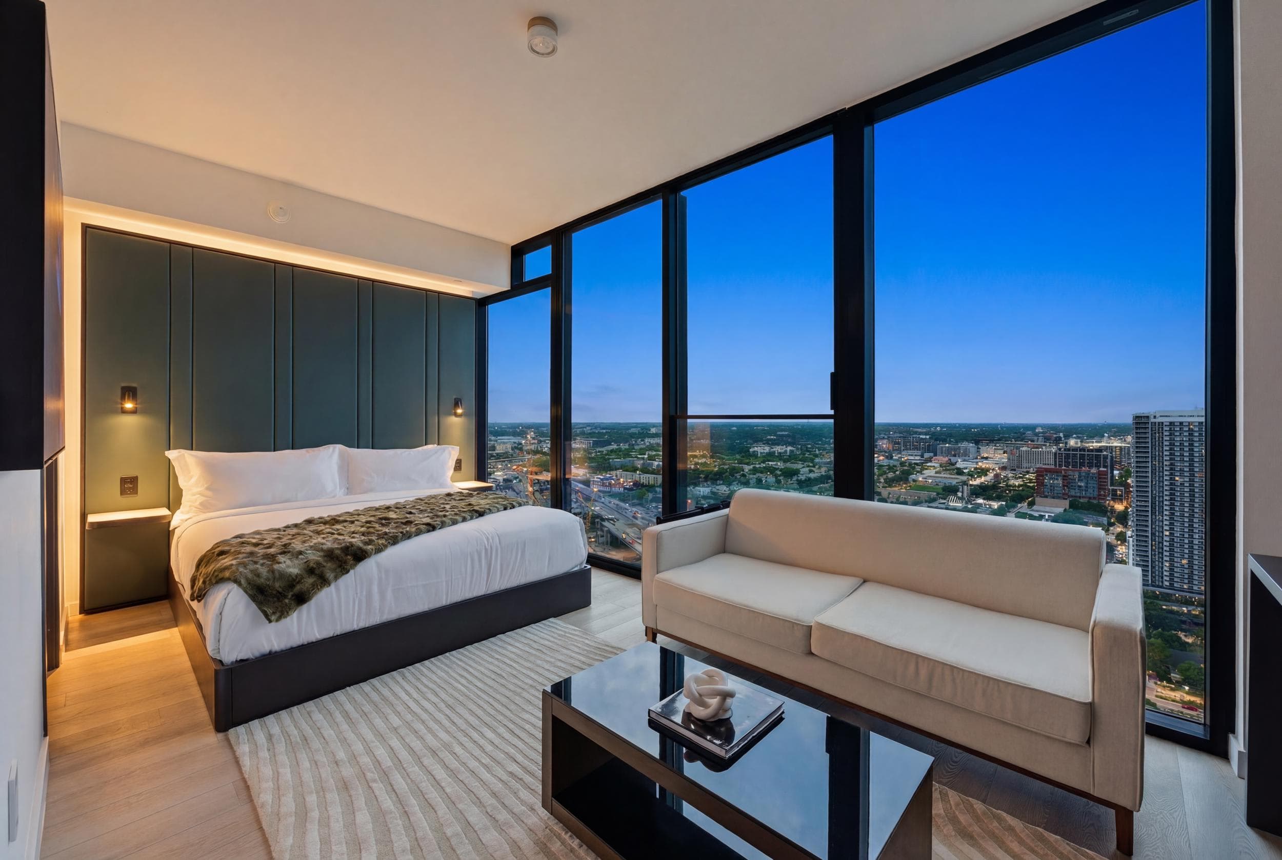 Stylish lounge area with large windows and city skyline.