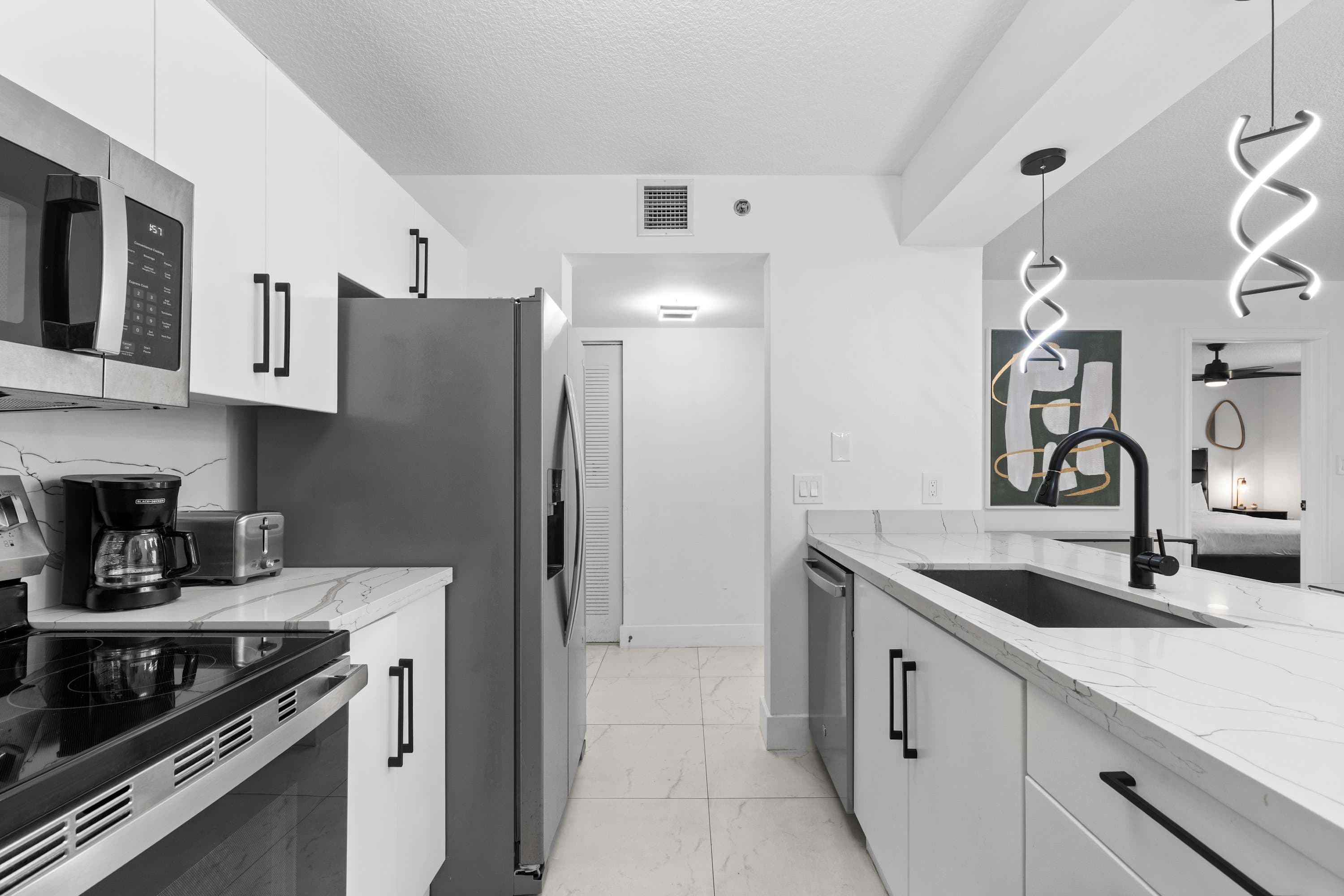 Kitchen with stainless steel appliances and a bar.